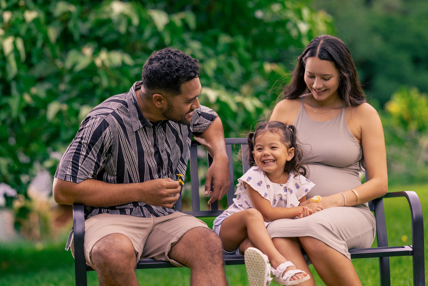 AlohaCare QUEST Medicaid family sitting together outdoors